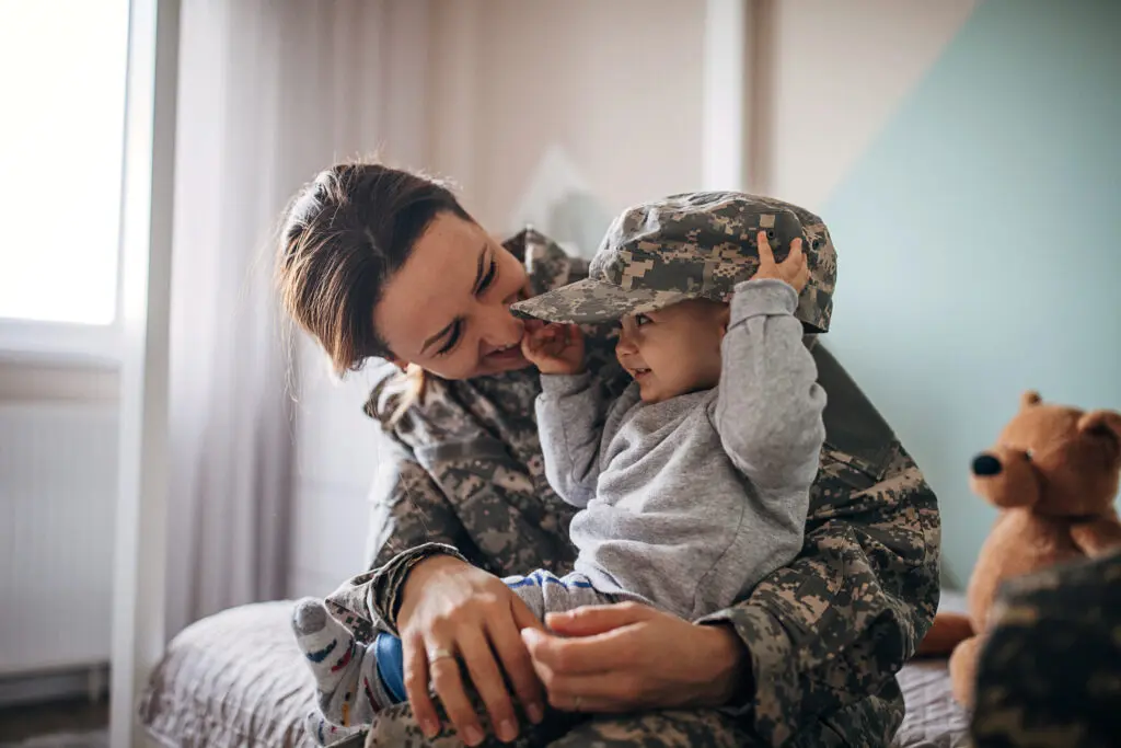 young woman soldier meeting her baby son after a long time