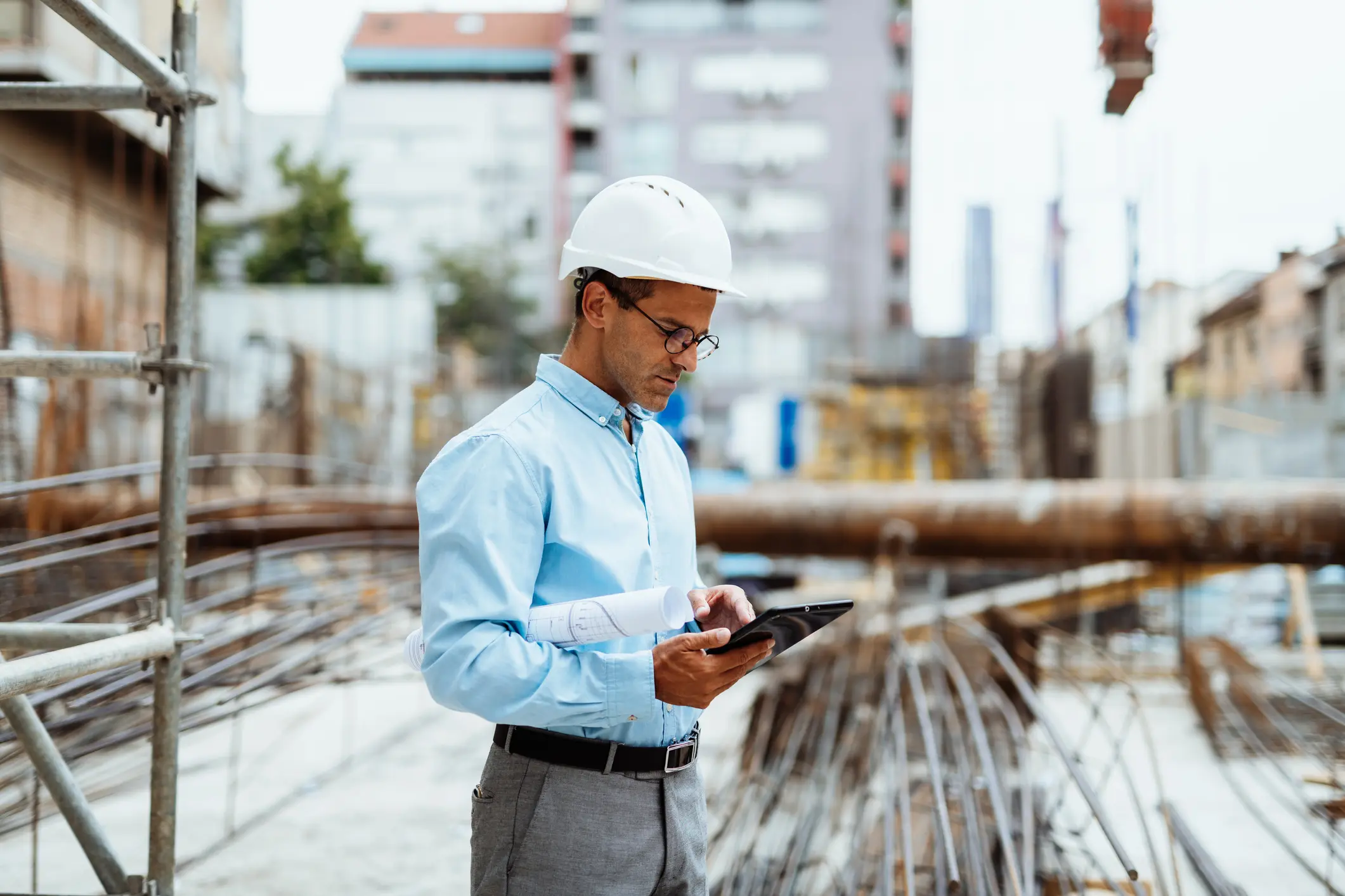 construction worker or engineer using digital tablet