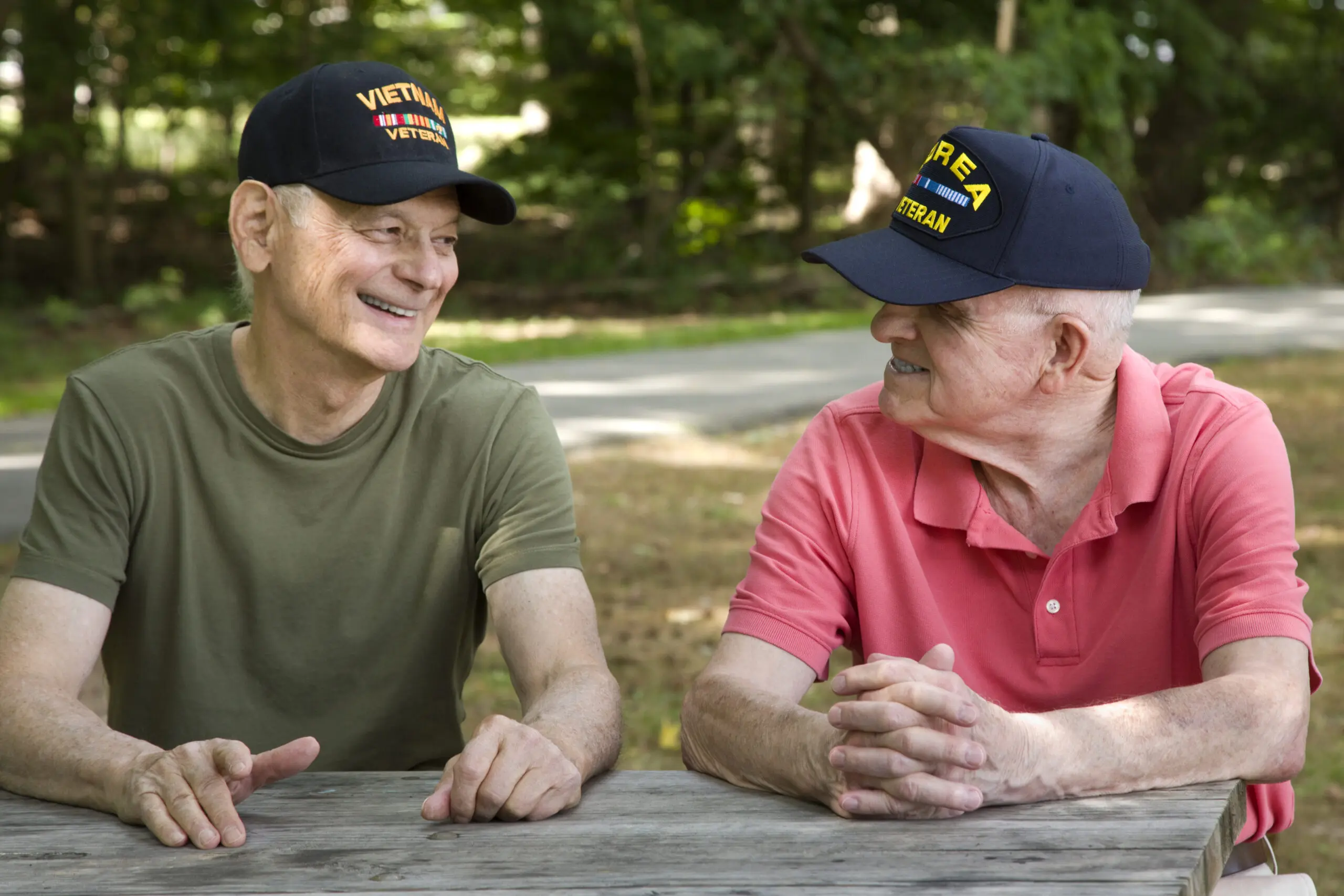 korean war and vietnam veteran smiling looking at each other