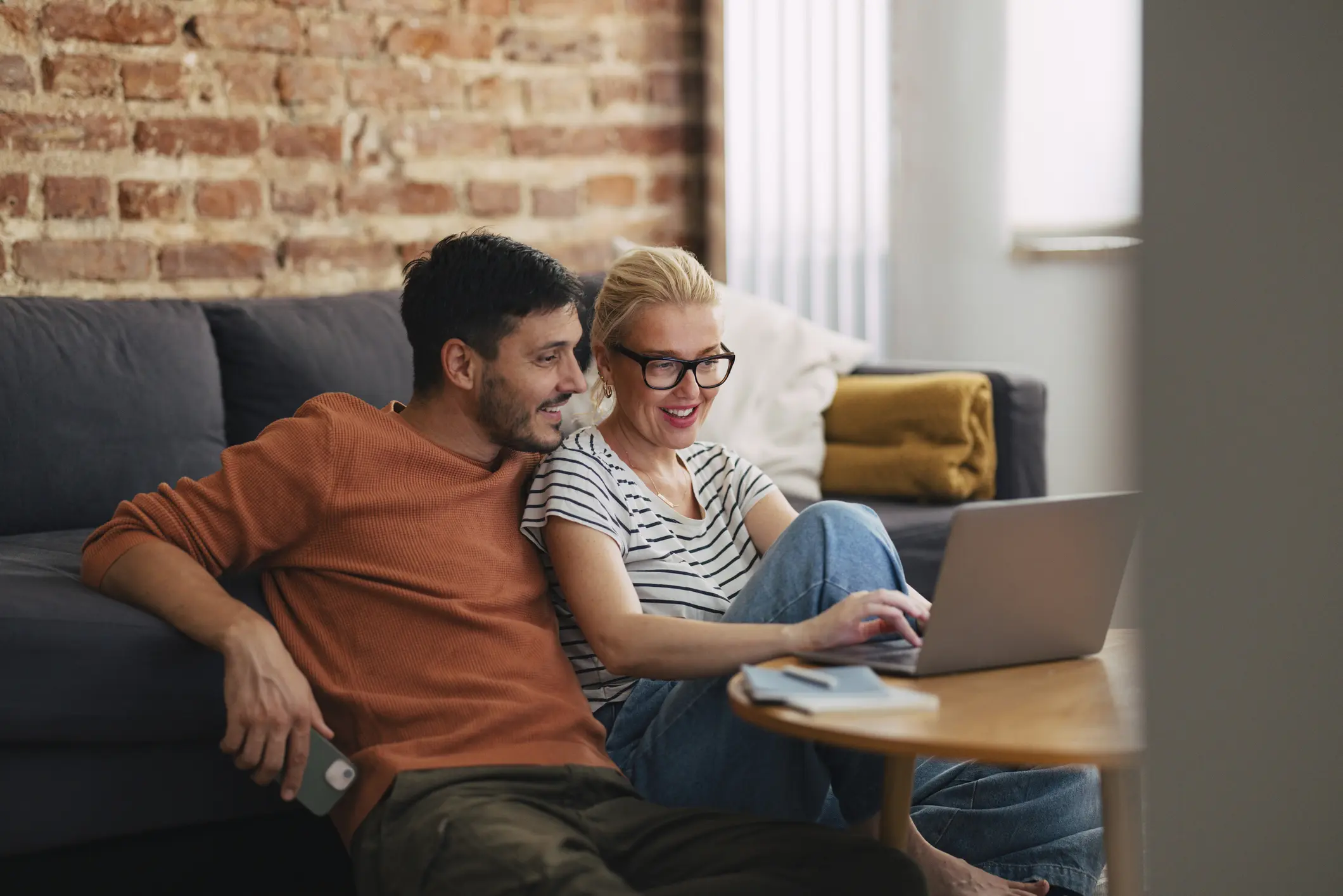 loving couple relaxing in the afternoon and watching something on the laptop computer