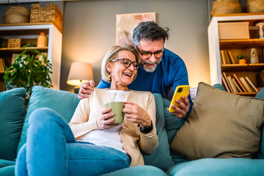 mature couple using mobile phone