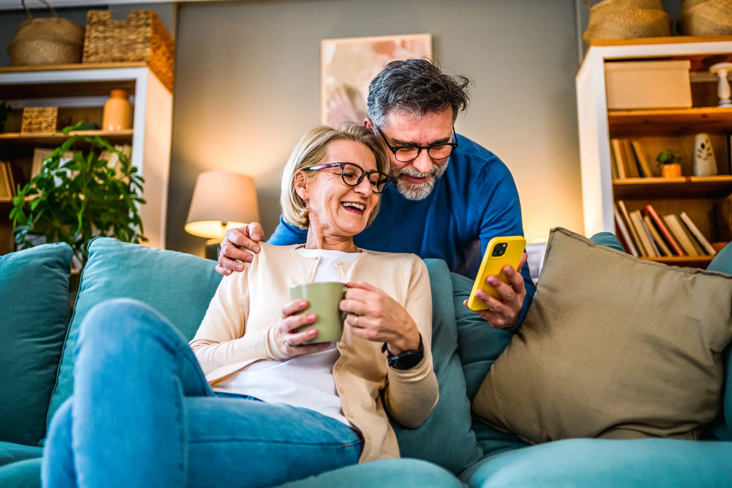 mature couple using mobile phone