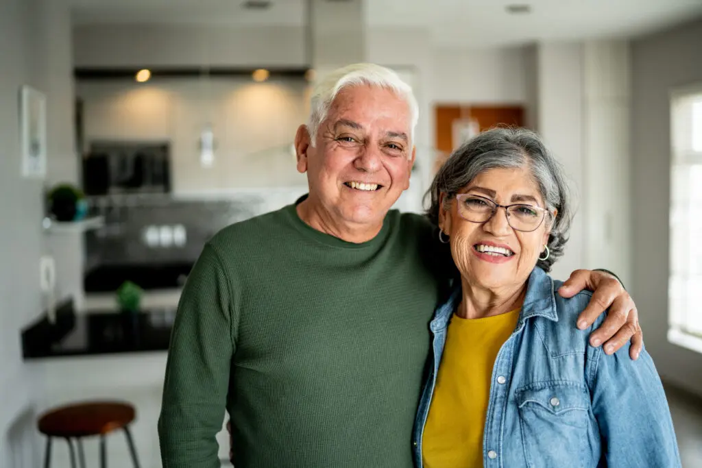 portrait of a senior couple embracing at home