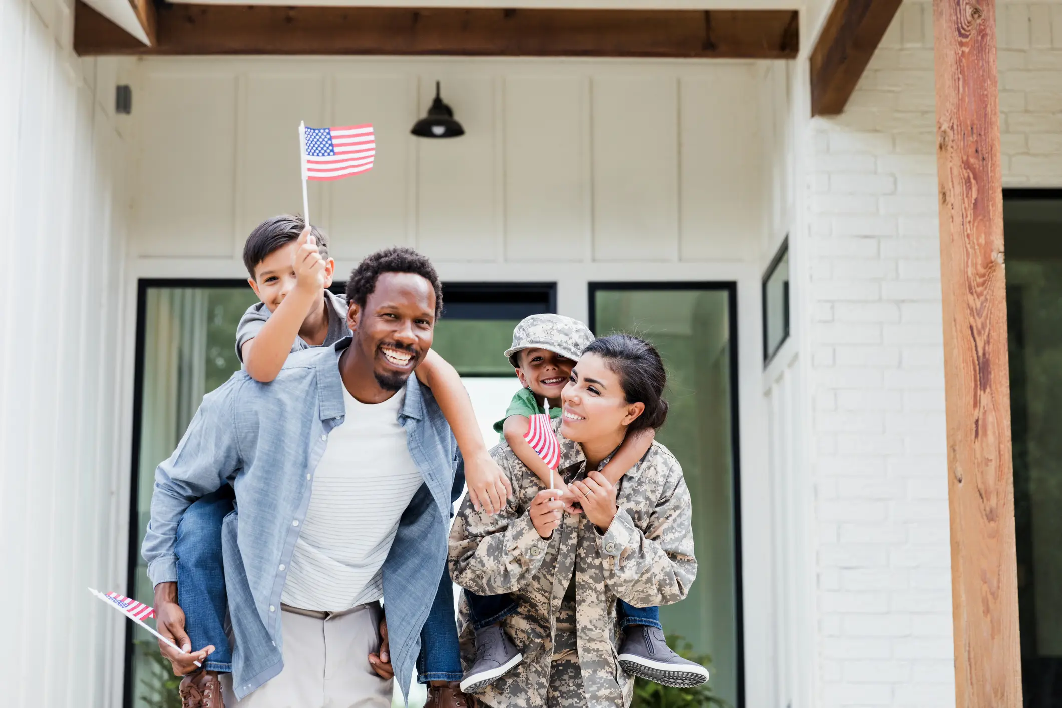 happy family welcomes home military mom with american flags