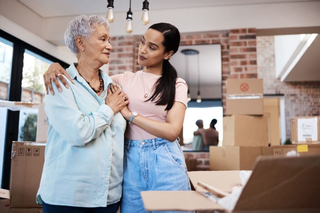 shot of a senior woman moving house with help from her daughter